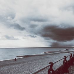 Scenic view of beach and sea against cloudy sky