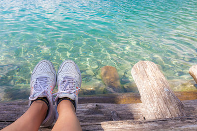 Low section of woman relaxing on shore