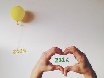 Cropped image of man holding hands over white background