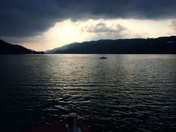 Scenic view of lake against cloudy sky