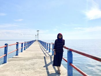 Woman standing on pier