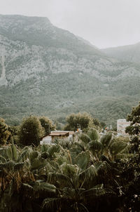 Scenic view of sea and mountains against sky