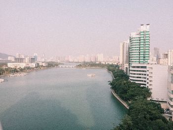 View of city buildings against clear sky