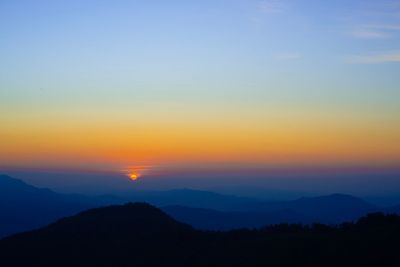 Scenic view of silhouette mountains against sky during sunset