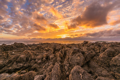 Scenic view of rock formations against sky during sunset