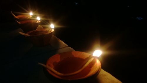 Close-up of lit candle in dark room