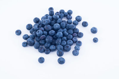 Close-up of berries over white background