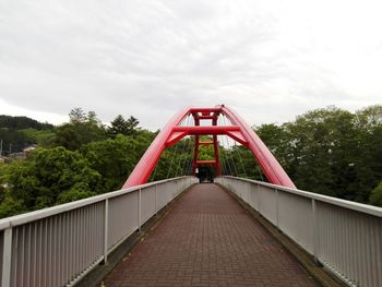 Low angle view of footbridge against sky