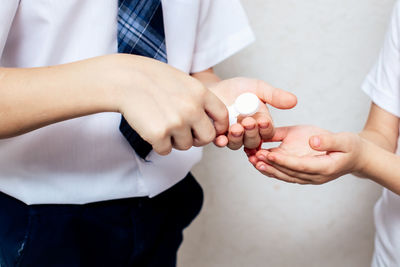 Midsection of couple holding hands