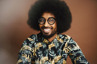 Portrait of smiling man with afro hairstyle in studio