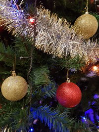 Close-up of christmas decoration hanging on tree at night