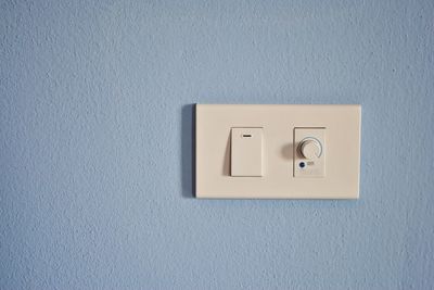 Light switch mounted on blue wall