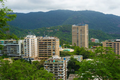 View of buildings in the middle of the rain forest in rio de janeiro.