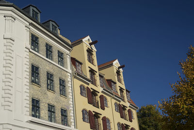 Low angle view of residential building against clear blue sky