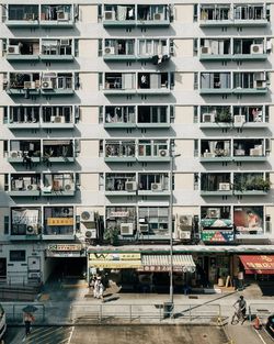 People walking on street against buildings in city