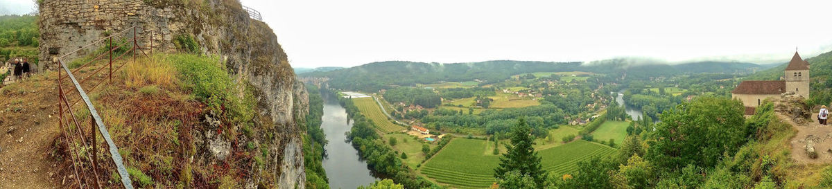 Panoramic shot of trees on landscape against sky