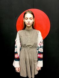 Portrait of a beautiful young woman over black background