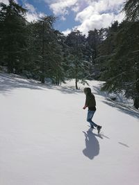 Full length of man standing on snow covered landscape