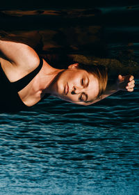 Portrait of young woman swimming in lake