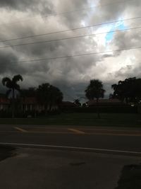 View of storm clouds over road