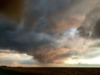 Scenic view of field against sky during sunset