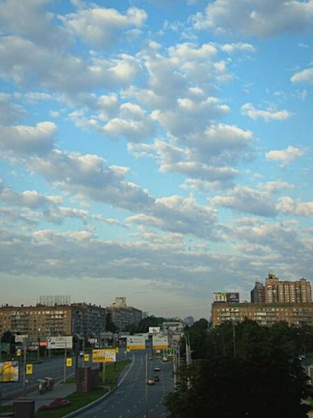 sky, building exterior, architecture, built structure, cloud - sky, transportation, city, cloud, cityscape, road, cloudy, high angle view, residential district, outdoors, residential building, day, no people, street, car, blue