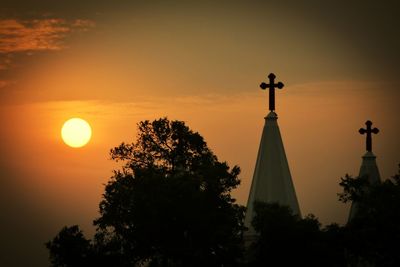 Silhouette statue against sky during sunset