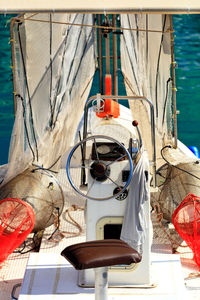 Close-up of rope hanging in boat against trees