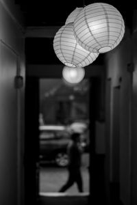 Close-up of illuminated lighting equipment hanging at night