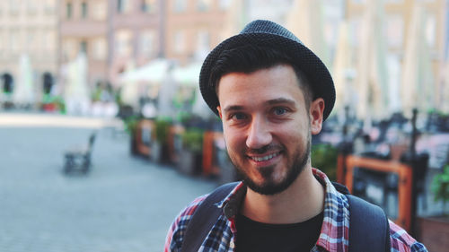 Portrait of smiling young man in city