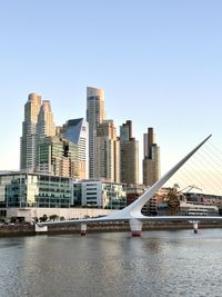 Buildings in city against clear sky