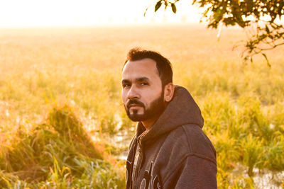 Portrait of man standing on field