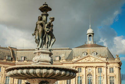 Low angle view of statue against cloudy sky