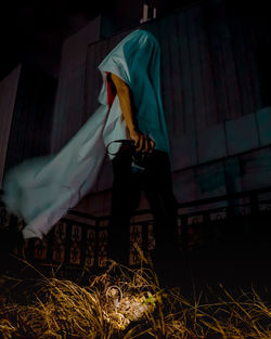 Midsection of woman standing at night