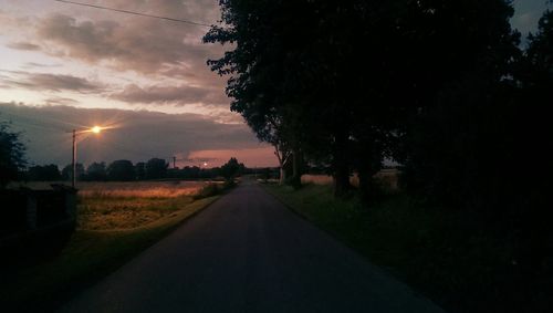 Empty road passing through field