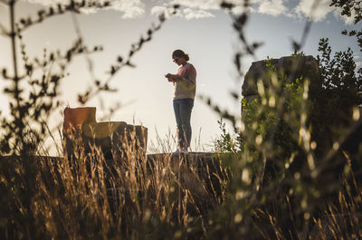 Man standing on field against sky