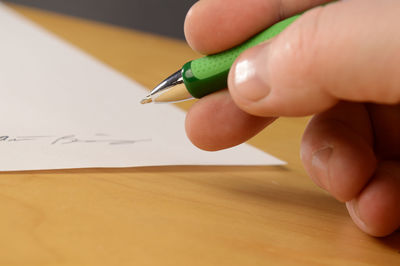 Close-up of hand holding paper
