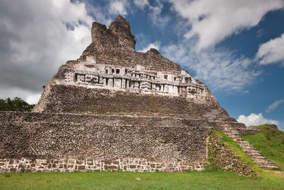 Low angle view of old building against cloudy sky