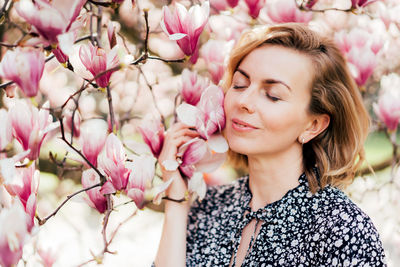 Portrait of beautiful woman with pink flowers