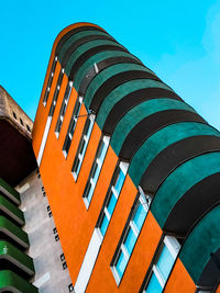 Low angle view of multi colored building against blue sky