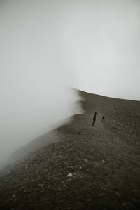 People walking on land against sky