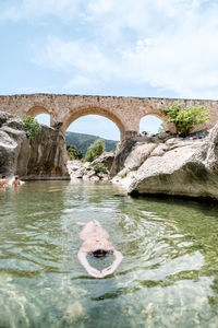 Woman swimming in a majestic and clear waters river in teruel, spain. 