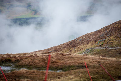 Scenic view of rainbow over land against sky
