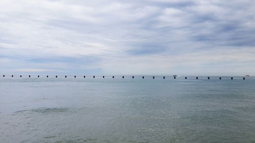 Scenic view of sea against cloudy sky