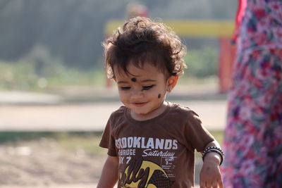 Portrait of cute boy standing outdoors, india male child  with india culture concept