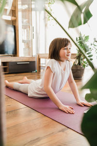 Yoga poses for kids. girl learning yoga at home online. sports life style. sports in children's live