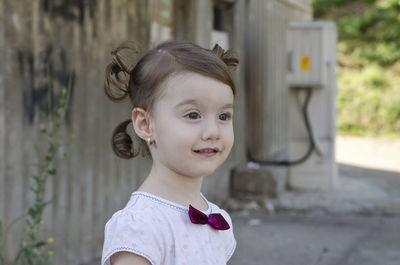 Portrait of cute girl standing outdoors