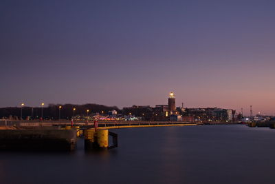 Illuminated cityscape against sky at night