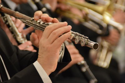 Close-up of hands playing flute