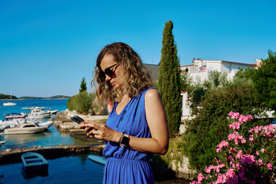 Woman using smartphone at summer vacation